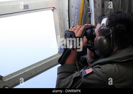 Kuala Lumpur. 13th Mar, 2014. A Malaysian air force soldier is seen during the search for the missing Malaysian Airlines flight, aboard C-130 transport aircraft March 13, 2014. The Malaysian air force Thursday morning sent an aircraft on an 8-hour search mission in areas around Subang, Penang, Phuket and Andaman Sea, but found no trace of the missing jetliner, the pilot of the mission said. Credit:  Xinhua/Alamy Live News Stock Photo