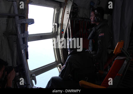 Kuala Lumpur. 13th Mar, 2014. A Malaysian air force soldier is seen during the search for the missing Malaysian Airlines flight, aboard C-130 transport aircraft March 13, 2014. The Malaysian air force Thursday morning sent an aircraft on an 8-hour search mission in areas around Subang, Penang, Phuket and Andaman Sea, but found no trace of the missing jetliner, the pilot of the mission said. Credit:  Xinhua/Alamy Live News Stock Photo