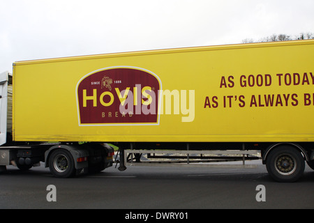 Side view of an articulated Hovis truck traveling around a roundabout in Coulsdon, Surrey, England Stock Photo