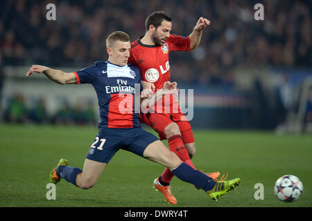 Leverkusen's Gonzalo Castro vies for the Ball with PSG's Lucas Digne during the UEFA Champions League round of 16 second leg soccer match between Paris Saint Germain and Bayer 04 Leverkusen at the Parc de Princes Stadium, Paris, France, 12 March 2014. Photo:: Federico Gambarini/dpa