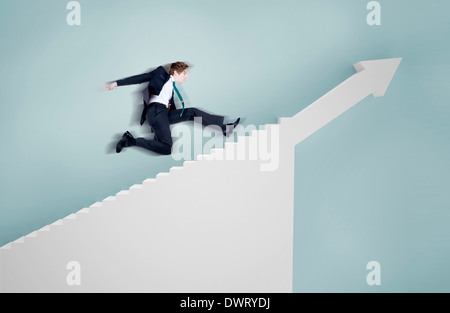 a businessman running towards stairs Stock Photo