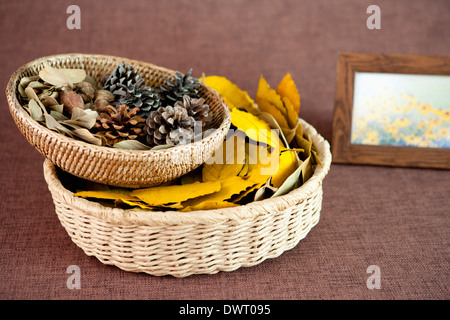 baskets full of autumn leaves and pine cones Stock Photo