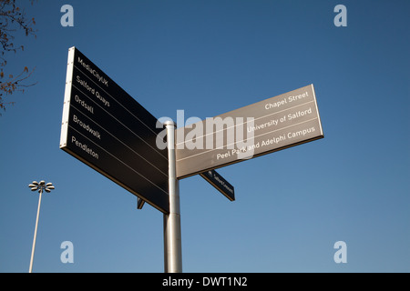 Street signs to different destinations. Roadside directional Tourist signs in Salford, Manchester, UK Stock Photo