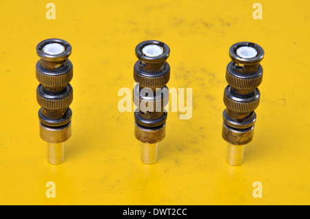 Used BNC connectors on yellow surface of device Stock Photo