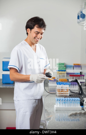 Man Scanning Barcode On Specimen Stock Photo