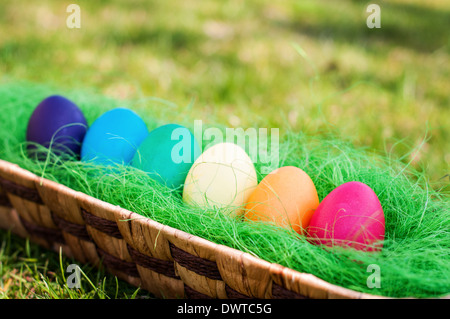 Easter eggs in a wooden basket in the garden Stock Photo