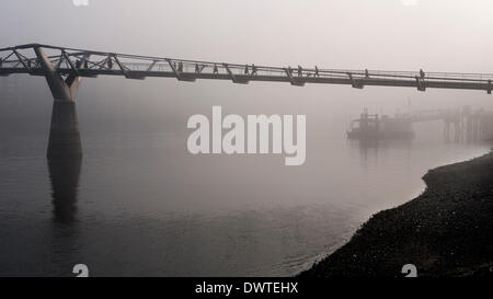 London, UK. 13th March 2014. The City Skyline disappears in this mornings heavy fog over London. Credit:  Lenscap/Alamy Live News Stock Photo