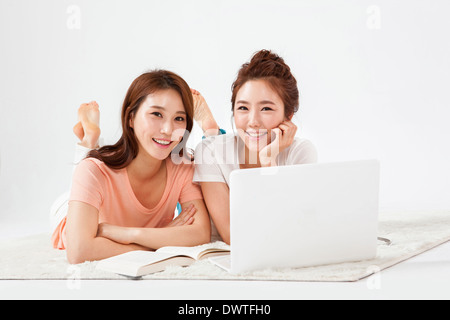 two women on the floor having fun Stock Photo