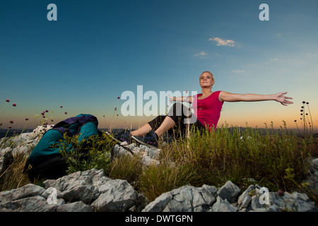 Woman on trekking - Beautiful blonde girl hiking on mountains Stock Photo