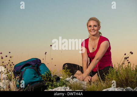 Woman on trekking - Beautiful blonde girl hiking on mountains Stock Photo