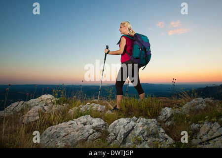 Woman on trekking - Beautiful blonde girl hiking on mountains Stock Photo