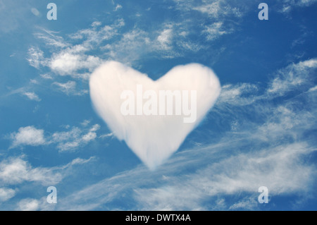 Cloud forming heart shape in blue sky, digital composite Stock Photo