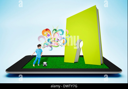 a boy playing soccer on a tablet Stock Photo