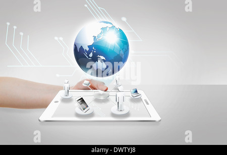 a tablet under the globe Stock Photo