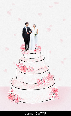a wedding couple standing on top of a cake Stock Photo