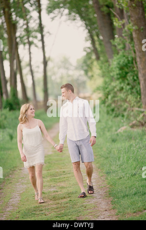 Couple walking down path together Stock Photo - Alamy