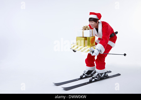 a man wearing a pair of skis and a Santa outfit Stock Photo