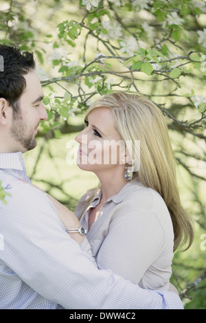 man and woman together in orchard Stock Photo