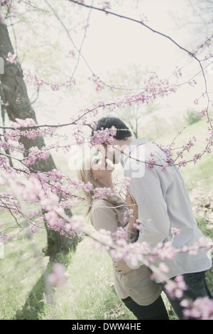 man and woman together in orchard Stock Photo