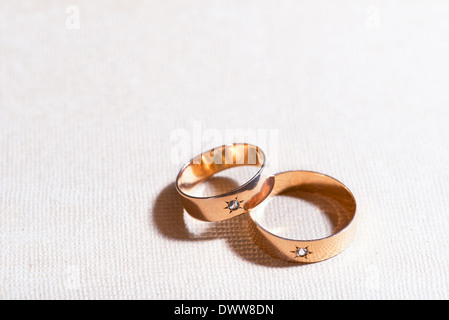 two golden wedding rings on the tablecloth Stock Photo