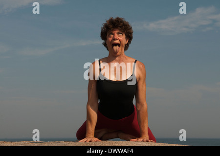 Iyengar ® Yoga Instructor Demonstrates Simhasana (Sitting). Stock Photo