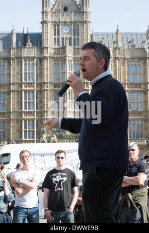 London, UK. 13th Mar, 2014.  Dominic Dyer of the Badger Trust speaks as protesters gather outside Westminster while a parliamentary debate on the controversial badger cull takes place inside the house of commons. Badgers have been linked to the spread of bovine tuberculosis in cattle and experimental culls of badgers were carried out in 2013 in an attempt to stop the spread of the disease. Anti-cull protestors have claimed that the cull is inefficient, inhumane and scientifically flawed. Credit:  Patricia Phillips/Alamy Live News Stock Photo