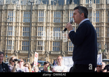 Dominic Dyer of the Badger Trust speaks as protesters gather outside Westminster while a parliamentary debate on the controversial badger cull takes place inside the house of commons. Badgers have been linked to the spread of bovine tuberculosis in cattle and experimental culls of badgers were carried out in 2013 in an attempt to stop the spread of the disease. Anti-cull protestors have claimed that the cull is inefficient, inhumane and scientifically flawed. Stock Photo