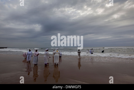 Woman sing as while they wait their turn to be baptised in the Indian Ocean on the Durban beach front, March 28, 2010. © Rogan Stock Photo