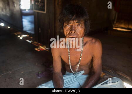Mar 2, 2014 - Ko Surin, Thailand - Akoo, an indigenous Moken man, in his home in Ko Surin National Park. Often called sea nomads or sea gypsies, the Moken are a seafaring people who for centuries lived nomadically on the Andaman Sea. However, due to stricter border control, commercial overfishing, rapid development, and tourism, the Moken have gradually been forced to adopt a settled lifestyle. Today, the Moken who live in Koh Surin National Park, one of Thailand's most remote group of islands, have it better than many of their kin and are still able to live a lifestyle largely based on tradit Stock Photo