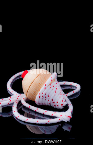 Classic spinning top game on black background Stock Photo