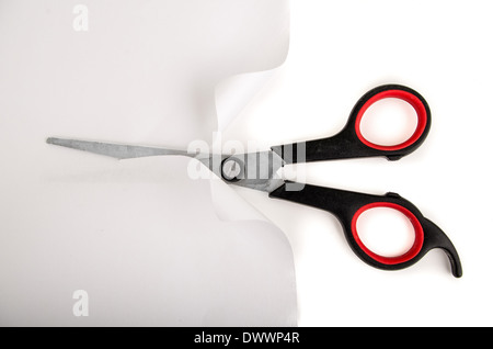 new scissors with black and red plastic handles, cutting paper Stock Photo