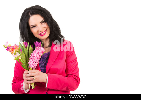 Happy woman in fuchsia jacket holding fresh spring flowers isolated on white background Stock Photo