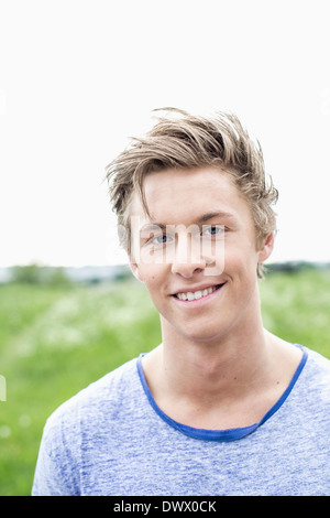 Portrait of young man smiling outdoors Stock Photo
