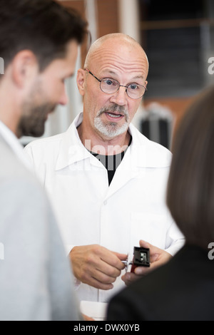 worker explaining how the machine works Stock Photo - Alamy