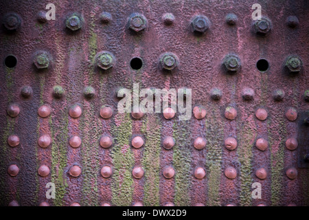Detail of a grungy, faded, red plate on the side of an old rusting steam engine in England, UK Stock Photo
