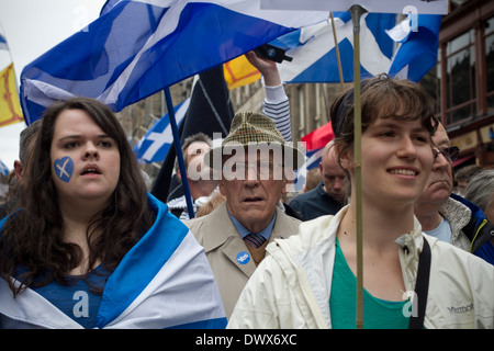 An elderly man and two women waiting on the Royal Mile for the start of a pro-Independence march and rally in Edinburgh. Stock Photo
