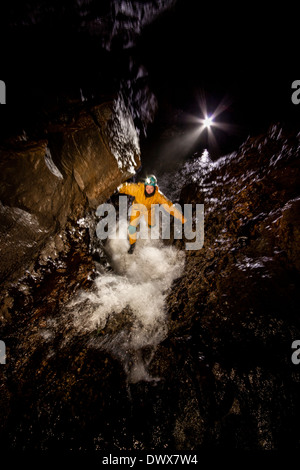 A caver in the stream passage, Ogof Ffynnon Ddu, Brecon Beacons, south Wales, UK Stock Photo