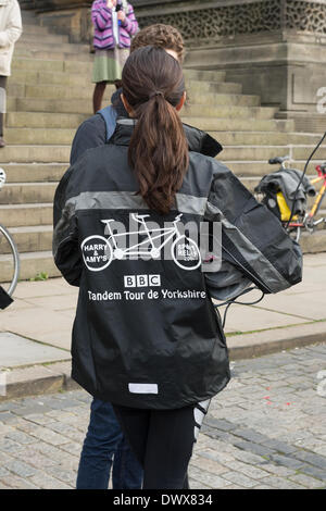 Amy Garcia (back to  camera) chatting before the start of Look North's Harry & Amy's Tandem Tour de Yorkshire in aid of Sport Relief - Leeds Town Hall, West Yorkshire, England, UK. Stock Photo