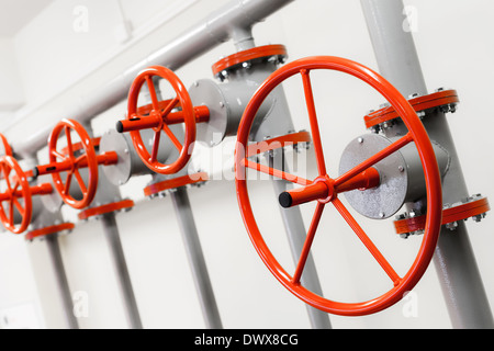 Group of red industrial valves on pipeline system Stock Photo