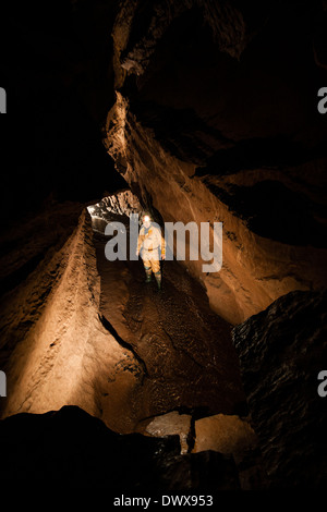 A caver in Piccadilly passage, Ogof Ffynnon Ddu, south Wales, Brecon Beacons, UK Stock Photo