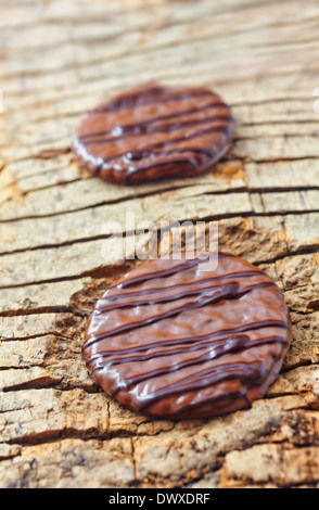 Decorated chocolate biscuit on wooden background. Stock Photo