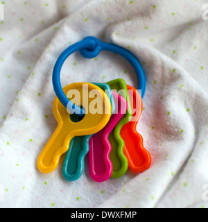 Baby toy keys on a soft white blanket Stock Photo