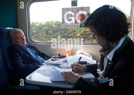 FILE PIX OF TONY BENN. Train, London to Manchester, UK. 2006 Tony Benn asleep on the train to Manchester while Bianca Jagger prepares her speech. The train was full of people heading to a Stop the War Coalition in Manchester called Time to Go an demonstration opposing the war in Iraq. Former politician and President of the Stop the War Coalition Tony Benn died March 13 2014 at 88. Credit:  Kristian Buus/Alamy Live News Stock Photo