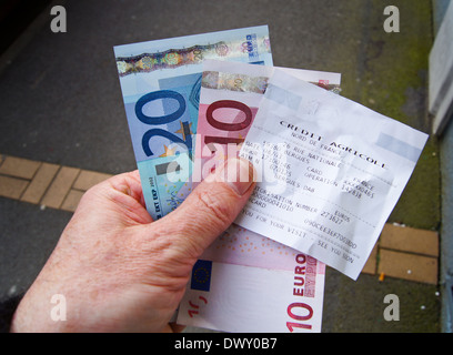 Closeup of a man's hand holding €30 euro withdrawn from a Credit Agricole cash machine in France Stock Photo