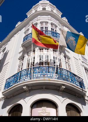 A Spanish flag, left, and a flag of the Canary Islands, right, wave in front of a building at Santa Cruz, La Palma, Canaries Stock Photo