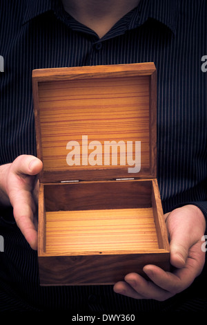 An empty casket in the hands of a man Stock Photo