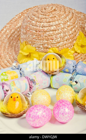 An image showing the concept of Easter with yellow chicks and colored eggs Stock Photo