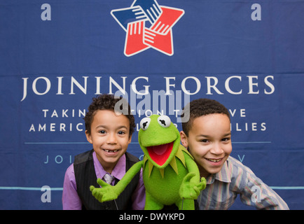 Children of military families pose with Kermit the Frog during a movie screening of the new Muppets movie, 'Muppets Most Wanted', at the White House March 12, 2014 in Washington, DC. Stock Photo