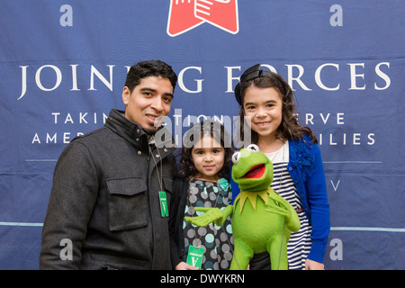 Military families pose with Kermit the Frog during a movie screening of the new Muppets movie, 'Muppets Most Wanted', at the White House March 12, 2014 in Washington, DC. Stock Photo