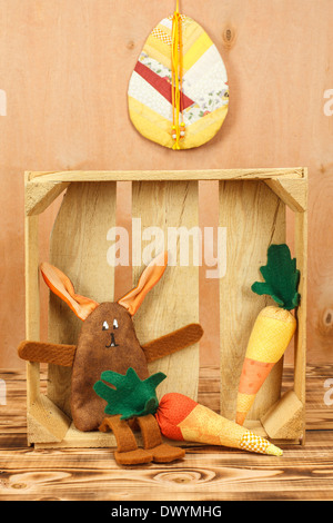 Home made fabric Bunny and 2 carrots Stock Photo